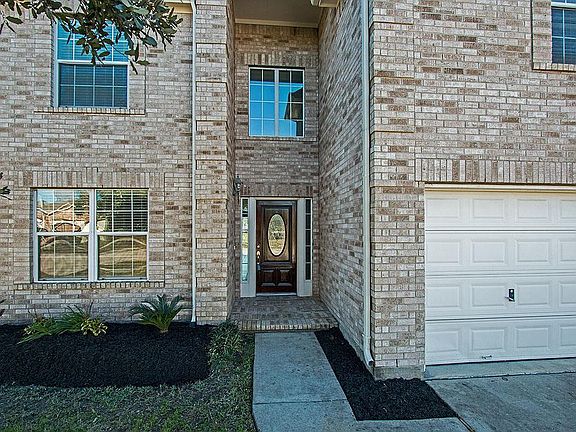 The mahogany door with sidelights welcomes you to this open and bright home.