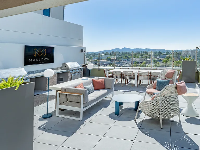 Rooftop terrace with outdoor seating and grill area