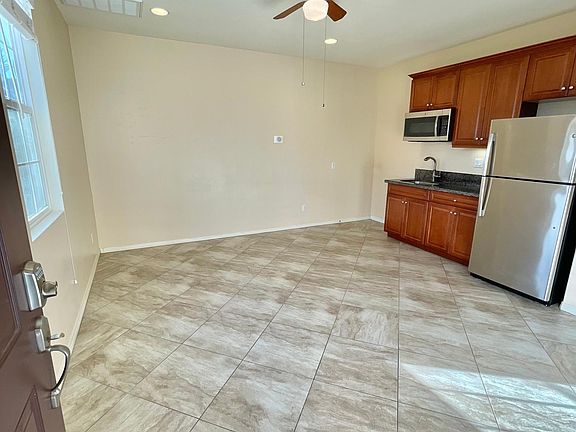 Spacious living room with dining and kitchenette. Full-size refrigerator and convection microwave that serves as an oven as well.