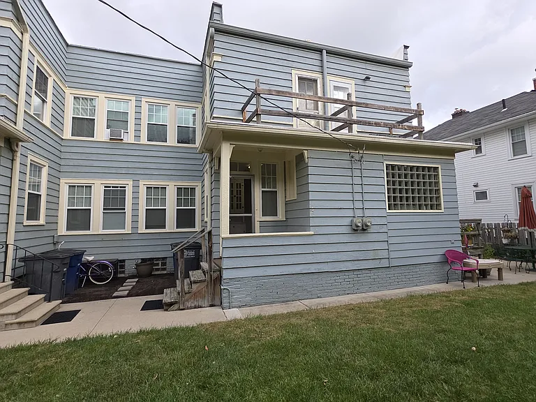 Back of townhouse shows balcony off BR 3 and back porch