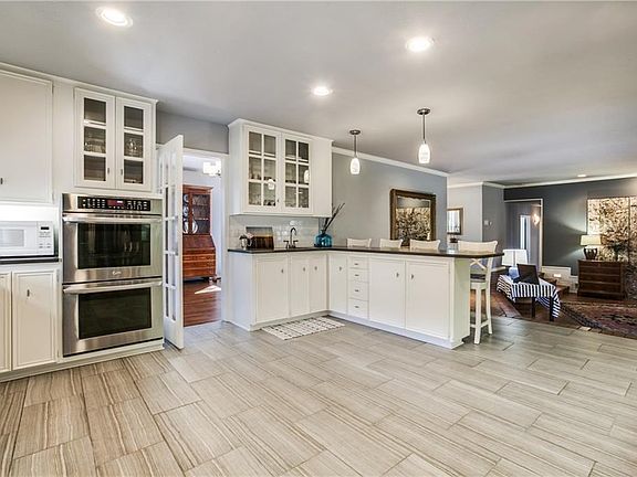 Double ovens and one is convection. Wet bar to the right. Kitchen is actually and eat-in if you prefer.