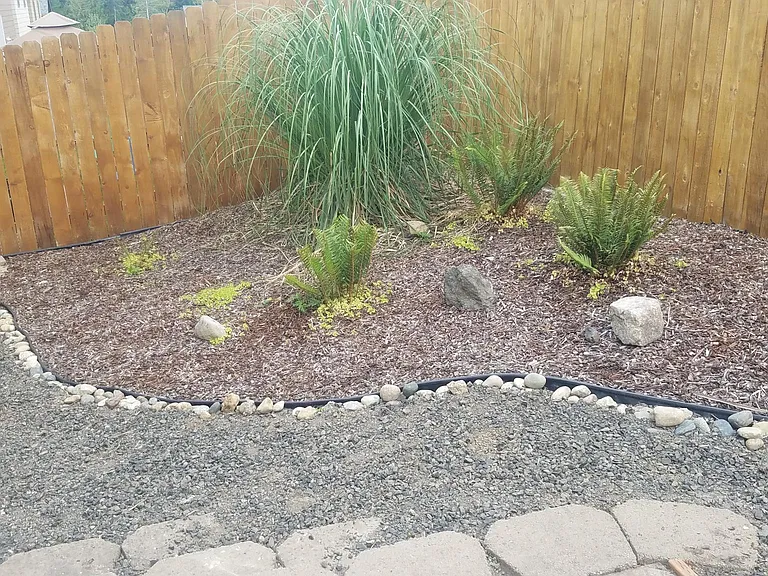 Fully fenced, low maintenance back yard with cement patio area.