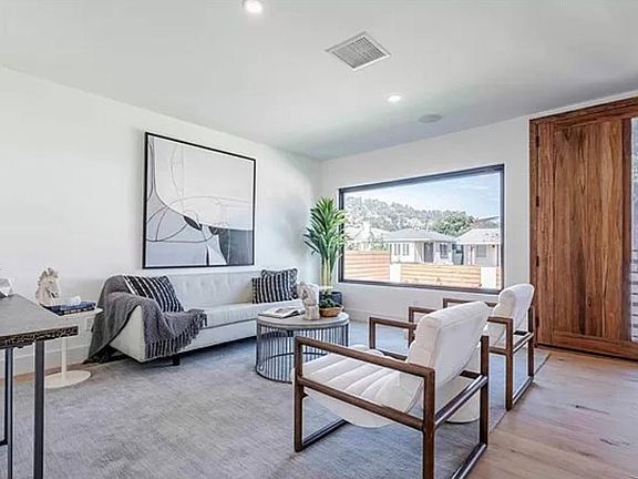 Walk in to a welcoming living space with a window looking out to the greenery of Elysian Park.