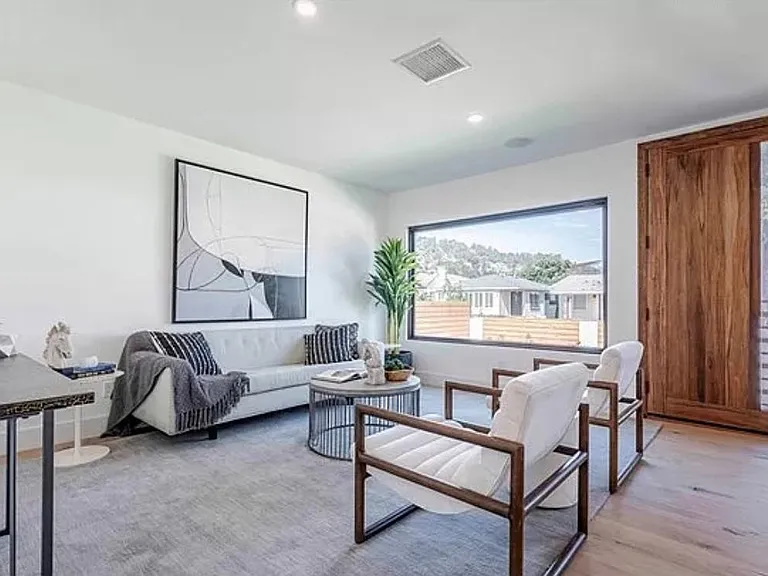 Walk in to a welcoming living space with a window looking out to the greenery of Elysian Park.