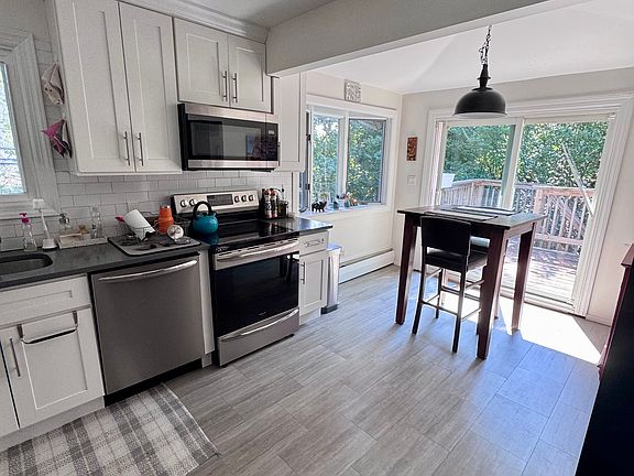 Kitchen including sliders to deck.