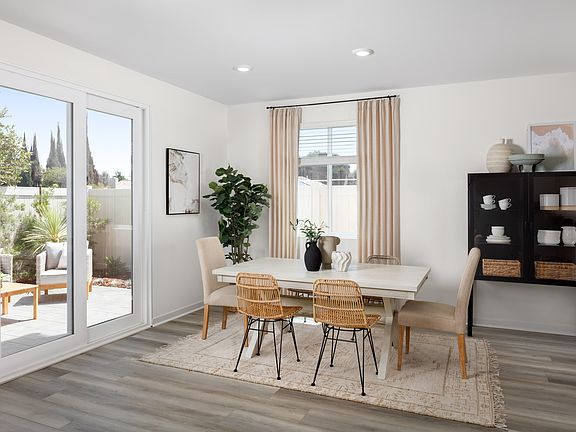 Model home dining area with upgraded flooring and natural light