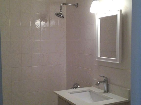 Hallway fully tiled bathroom