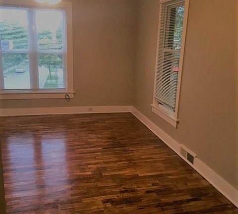 Living room has a ceiling fan/light combo