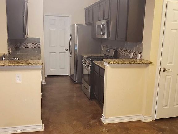 You take a broader look and see the entire kitchen and notice the closet by the front door..