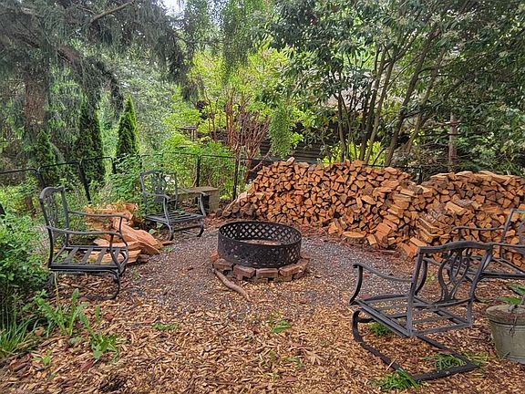 Sizable yard with outdoor firepit.