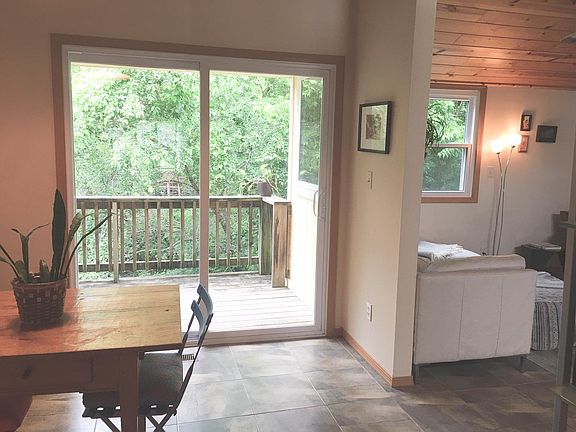 Dining area with access to balcony overlooking green space