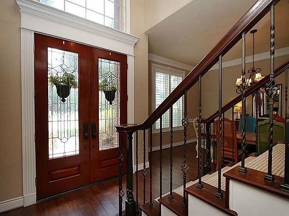 Sellers updated home with Wrought iron balusters  on the split stairway