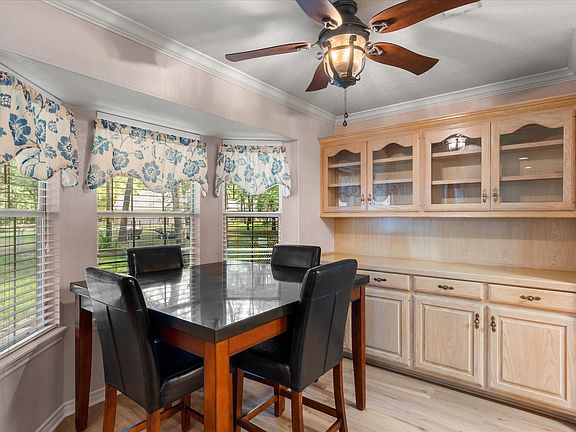 Integrated built-in cabinetry with glass-front upper cabinets and lower storage