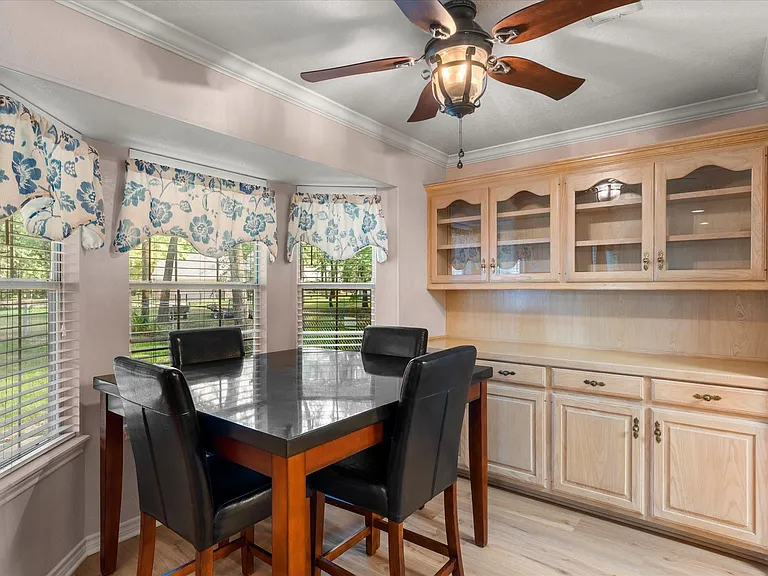 Integrated built-in cabinetry with glass-front upper cabinets and lower storage