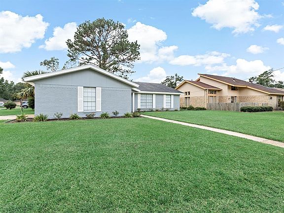 Another view of the front with the sidewalk leading to the front door. This home sits on a large corner lot!
