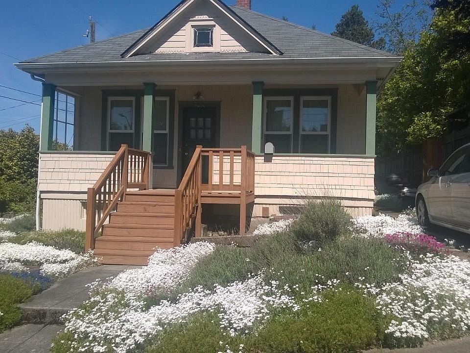 Front of house with parking spot to right.