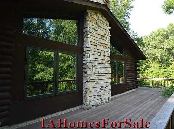 Great Room with hickory floors and Stone City limestone wood fireplace.  (Living = 15x15 and Dining = 15x15)
