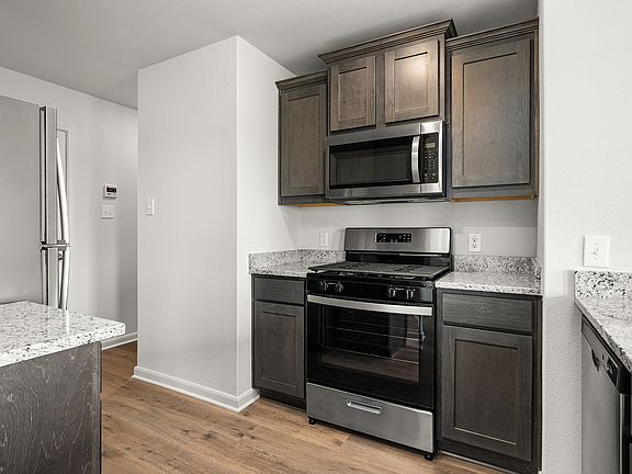 The kitchen has sprawling granite countertops.