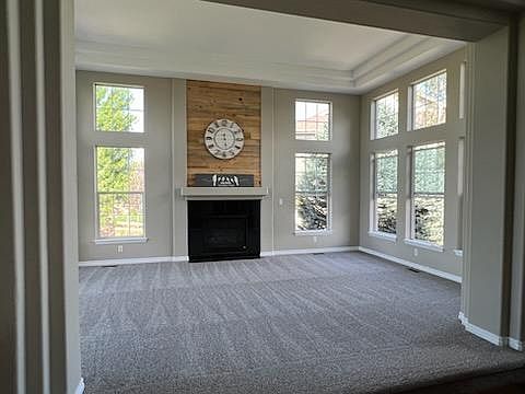 Formal great room with gas fireplace and windows on 3 walls!