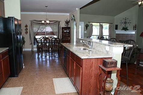 New slab granite and stone backsplash with stained cabinets