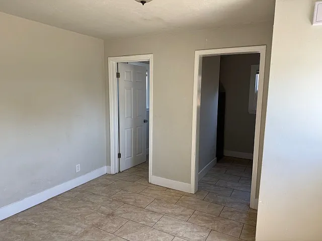 Doorways leading to bathroom and kitchen