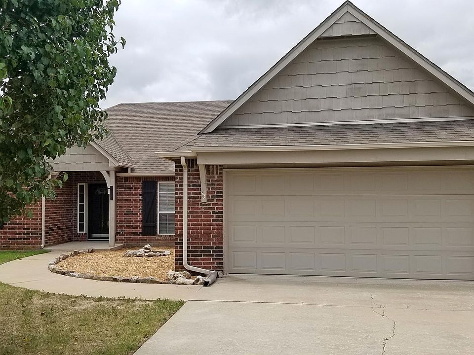Two car garage. Driveway. Simple and easy to care for yard a