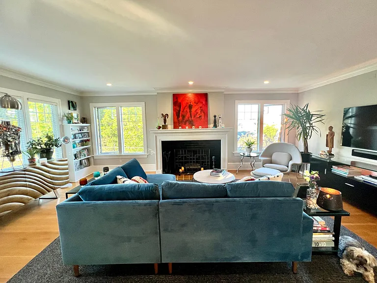 Living Room with large windows and lots of natural light. Living room is perched up off the street with great views of the surrounding neighboorhood.