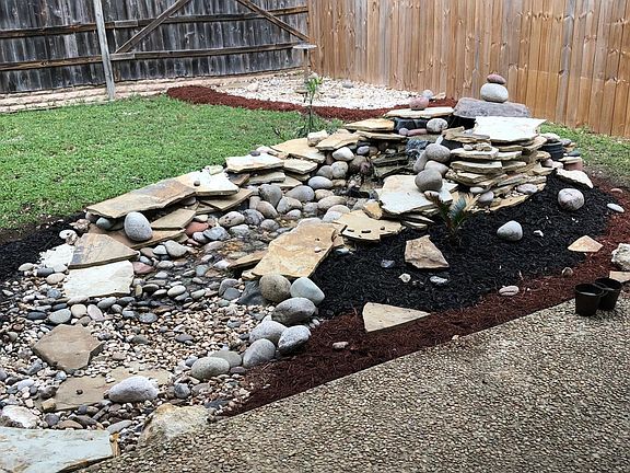 water feature in the back yard next to patio
