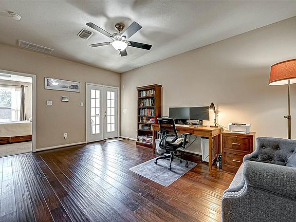 Views of the 1st floor offering large study area with rich hardwood flooring, access to the master bedroom and double glass paneled doors opening up to the back yard. This spacious area could also make a second living, library or hobby room. The poss