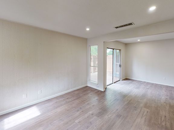 Light-filled living room with an open layout connecting to the kitchen.