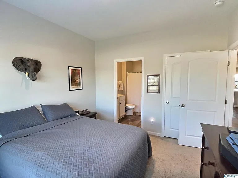 Isolated bedroom with ensuite bathroom near entryway