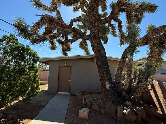 Walkway from the house to the garage. All of the areas are concrete for walking around the house. It has new outdoor lighting, but it is not in this photograph.