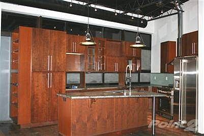 Another view of the kitchen-notice abundance of shelves on the left end and natural light coming from window under the cabinets.