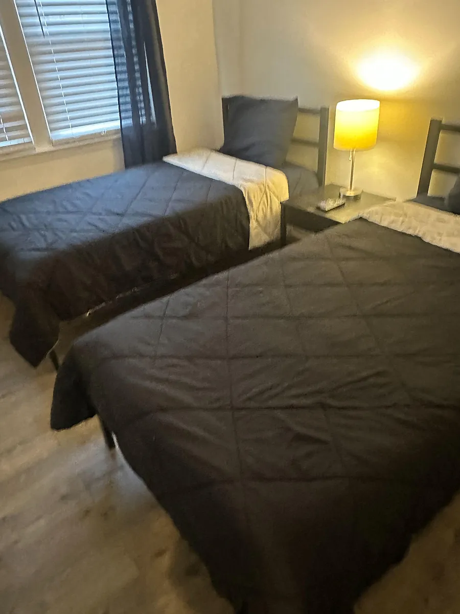 Bedroom has nightstand and lamp. - Woodymore Dr