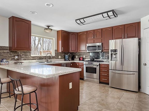 Kitchen features custom 42" cabinets accented with a beautiful backsplash, granite countertops, SS appliances, gas range, walk-i