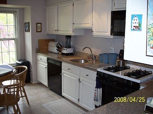 Renovated kitchen with granite countertops.