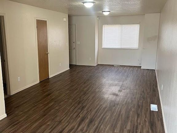 LIVING ROOM WITH DOORS TO HALF BATH AND LAUNDRY ROOM