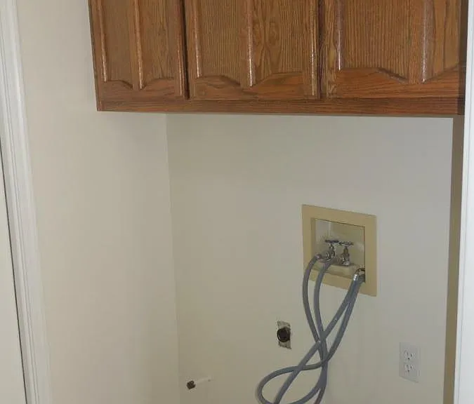 Large laundry area with cabinets