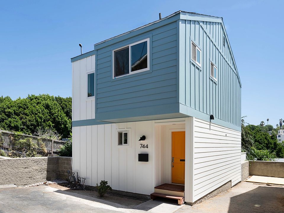 Exterior of townhouse. Two tandem parking spaces pictured on right side of photo.