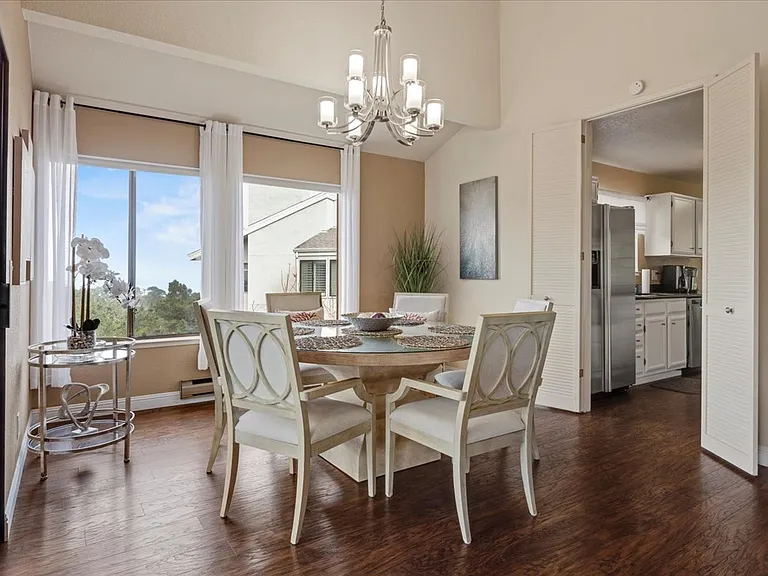 Dinning area with really lush comfortable chairs seating for 6. Beautiful hardwood floors and plenty of light with ocean views.