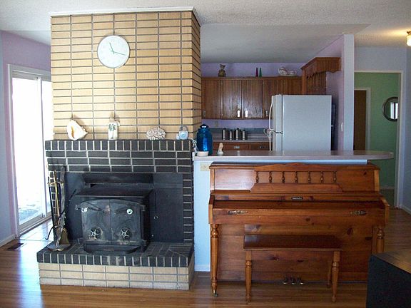 Fireplace and half wall to Kitchen