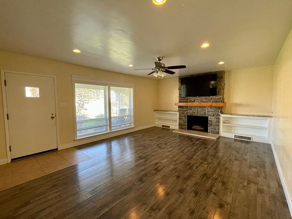 Front room with wall mount TV bracket above fireplace