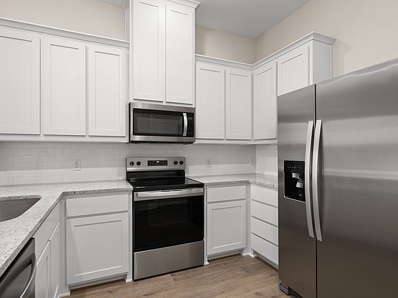 The kitchen has a beautiful tile backsplash.