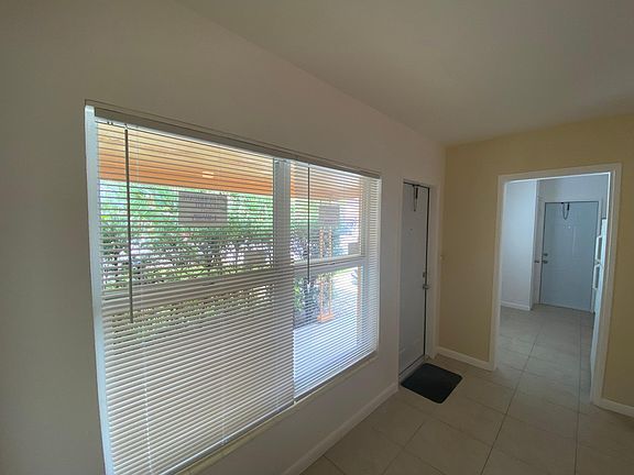 Picture from the living room showing the main entrance and the second door located in the kitchen.