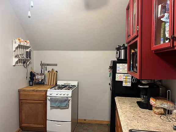 Kitchen includes gas stove and refrigerator