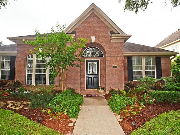 THE LUSH LANDSCAPING ENHANCES THIS BRICK BEAUTY!