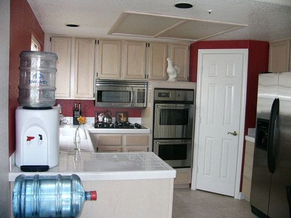 Nicely designed kitchen with stainless steel appliances and a walk-in pantry
