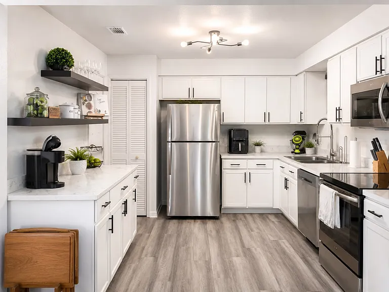 Functional kitchen with ample cabinet, counter space and stainless steel appliances.