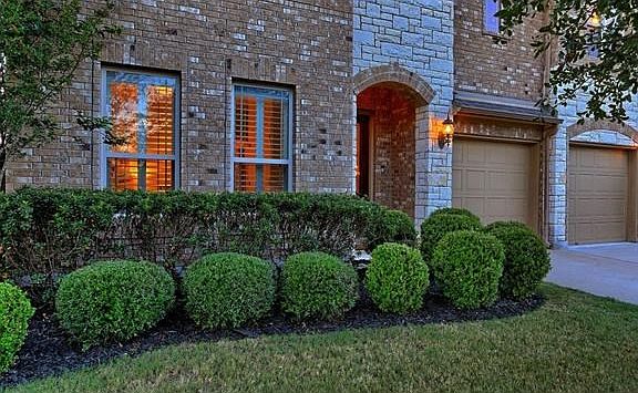 Shaped shrubs in front of home.