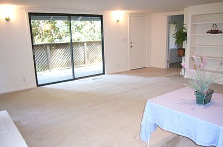 Livingroom with built in bookshelves and sliding glass door